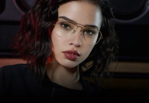 Gold wireframe aviator style glasses on a young woman