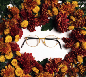 Eyeglasses surrounded by a fall bouquet
