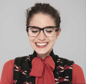 Woman laughing and wearing trendy oversized plastic frames