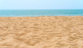 Sandy beach overlooking a blue ocean