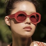 a woman wears longchamp red sunglasses